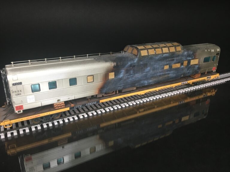 Atlas HO scale 89’ flatcar with Fire Damaged passenger car Protoloads